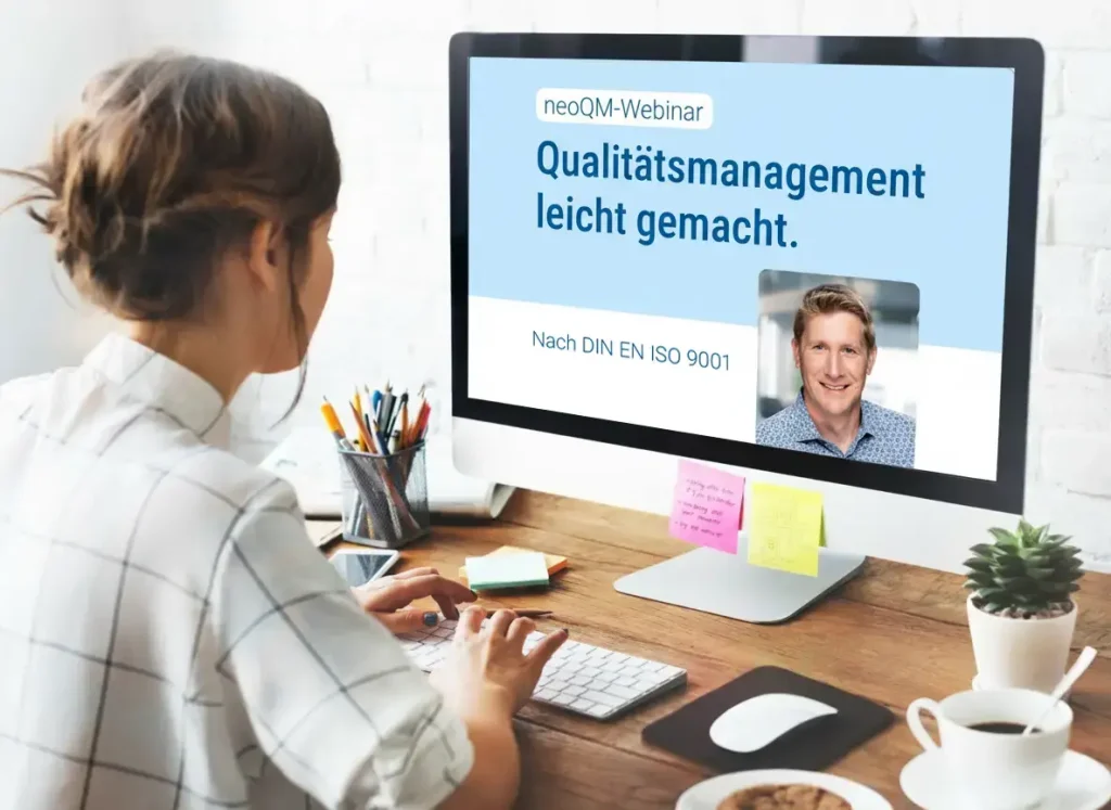 Eine Person am Schreibtisch betrachtet am Monitor die Ankündigung für das neoQM-Webinar.